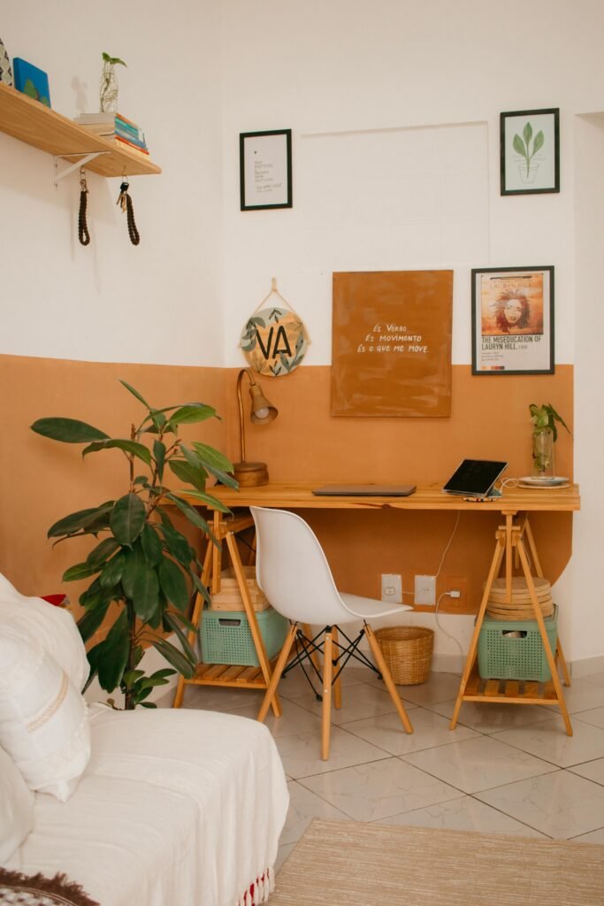A warm and inviting home office with a wooden desk, greenery, and minimalist design elements.