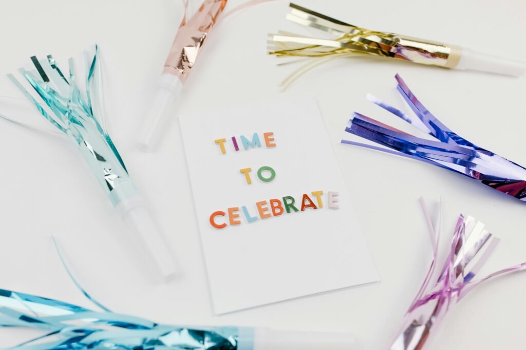 Festive card reading 'Time to Celebrate' surrounded by colorful party blowers.